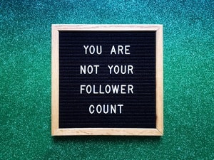 Growing your following on social media blackboard with words "You are not your follower count"